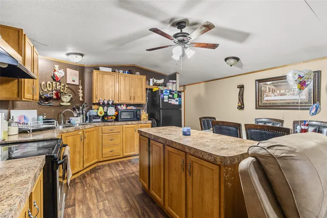 a kitchen with a stove a sink a dining table and chairs