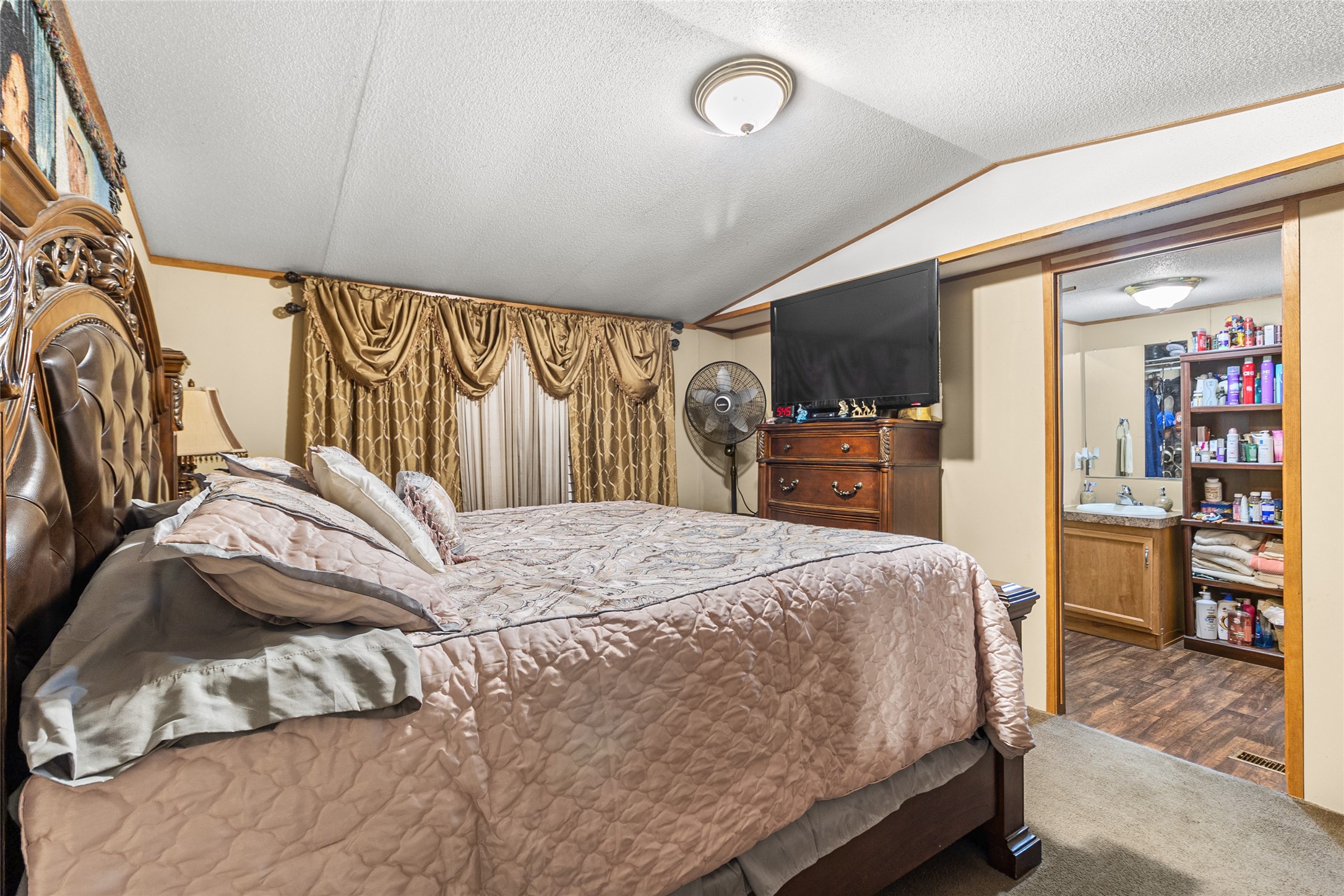 228 Geneva Road Huntsville, TX 77320 - Photo 9 of 26 a bedroom with a bed and a large mirror on the dresser
