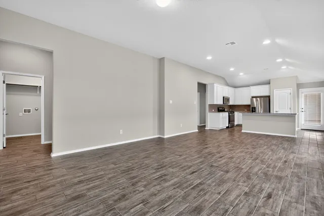 a view of large open kitchen with wooden floor