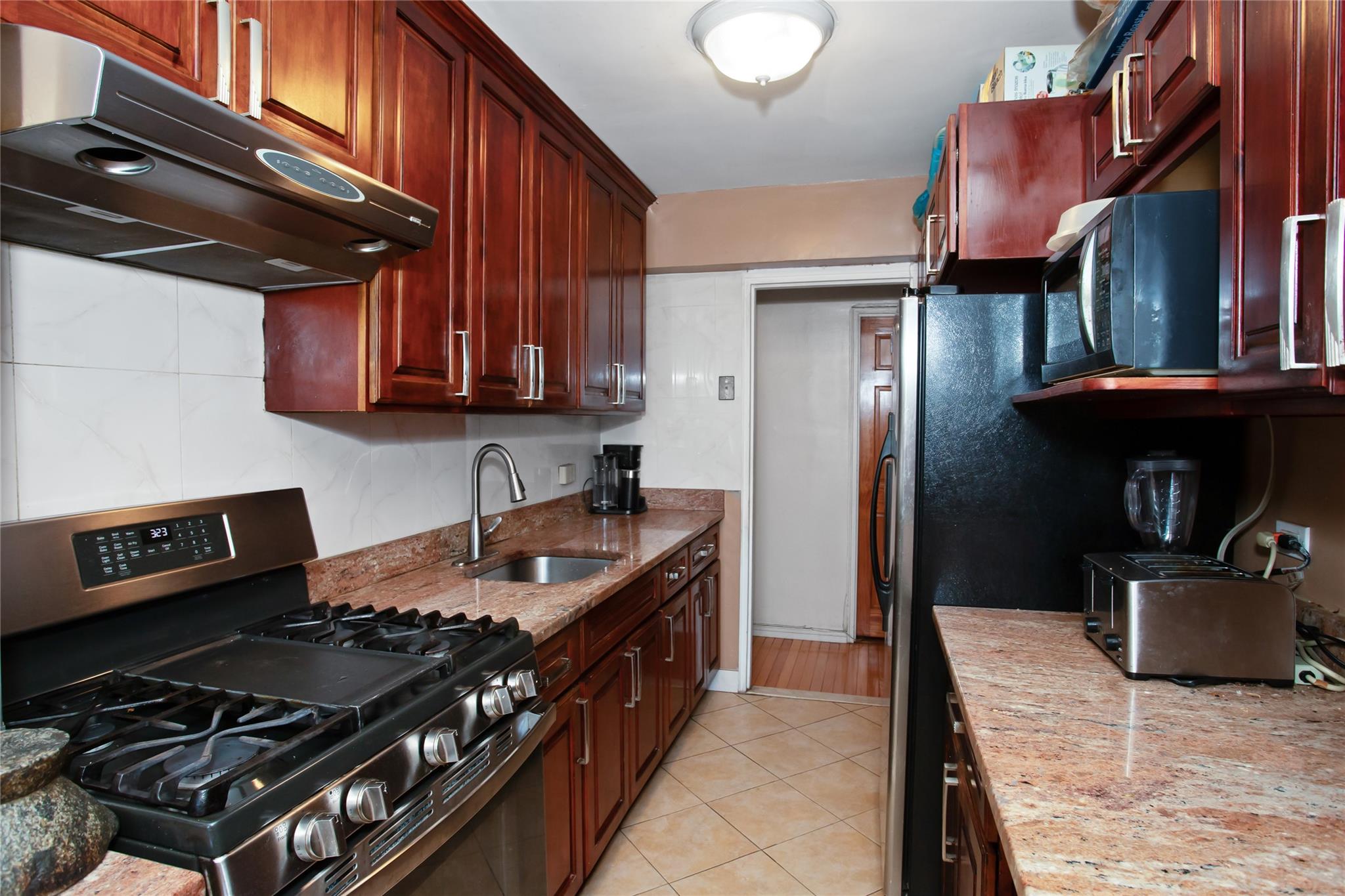 a kitchen with stainless steel appliances granite countertop a stove and a refrigerator