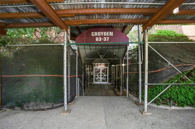 a couple of cars parked in front of building