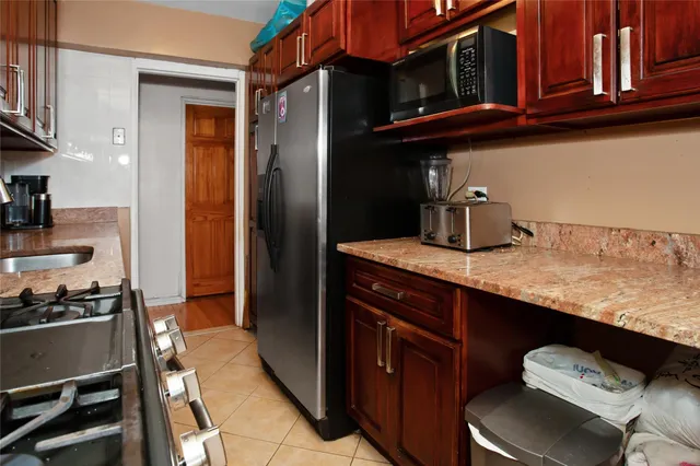 a kitchen with stainless steel appliances granite countertop a sink and cabinets