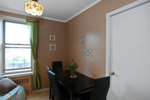 a dining room with furniture and a window