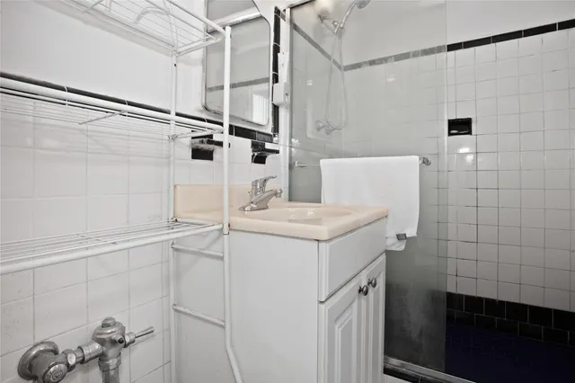 a bathroom with a sink a vanity and shower
