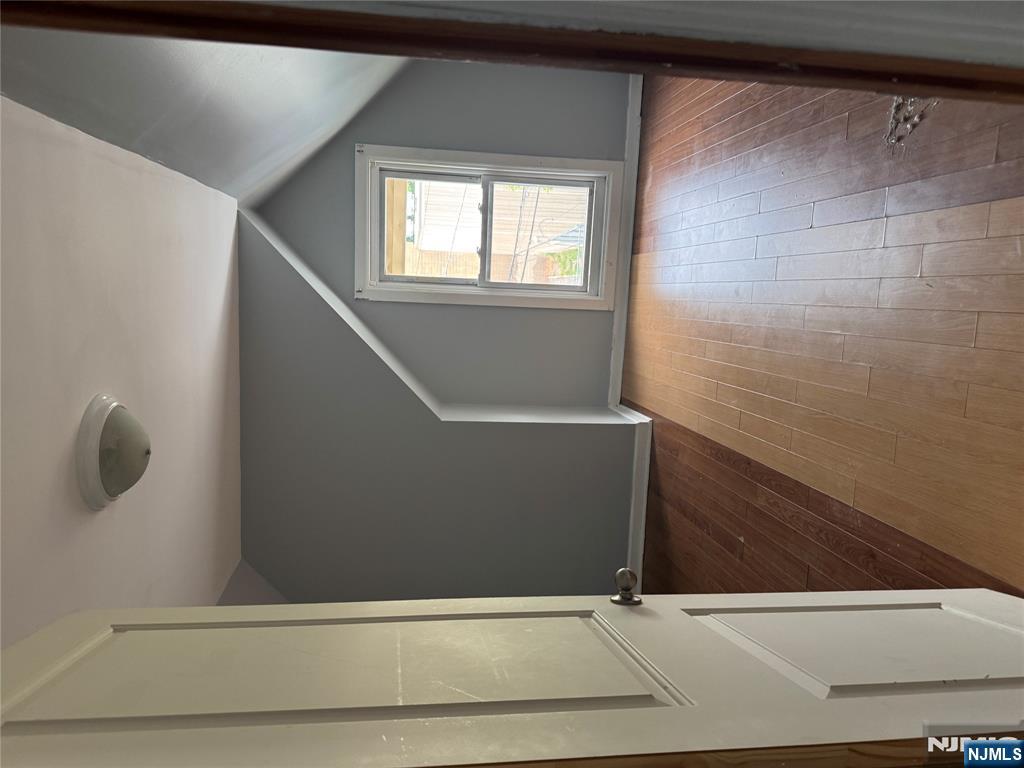 157 3rd Street, Unit 155 Newark, NJ 07107 - Photo 3 of 12 an empty room with wooden floor and windows