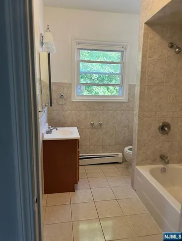 a bathroom with a sink a mirror and a window