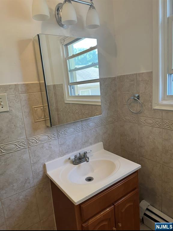 157 3rd Street, Unit 155 Newark, NJ 07107 - Photo 6 of 12 a bathroom with a sink a mirror and a window