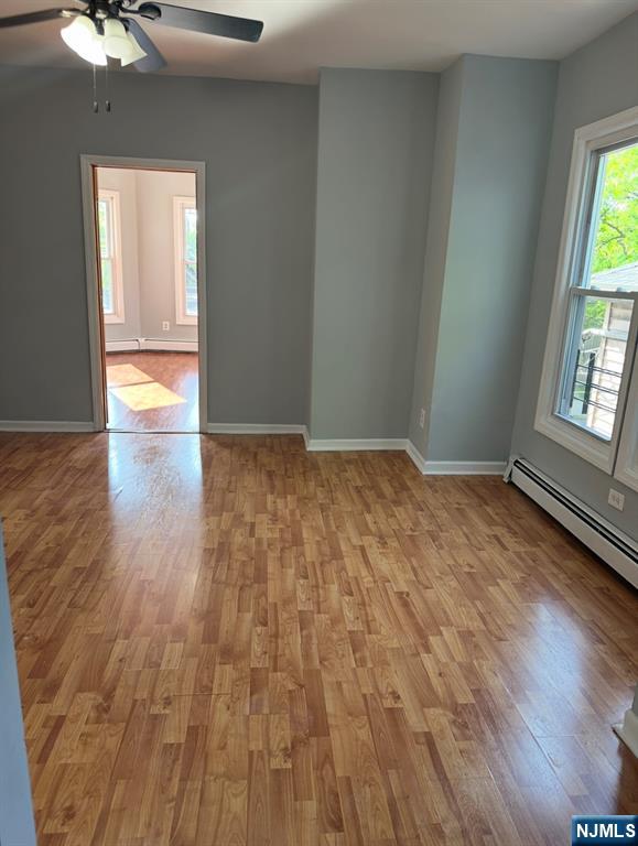 157 3rd Street, Unit 155 Newark, NJ 07107 - Photo 7 of 12 wooden floor in an empty room with a window