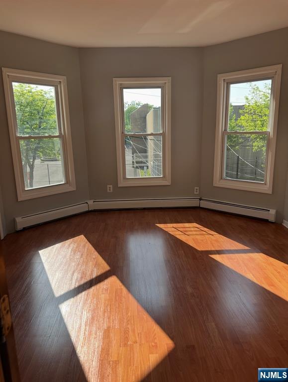 157 3rd Street, Unit 155 Newark, NJ 07107 - Photo 9 of 12 an empty room with wooden floor and windows
