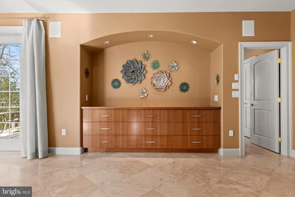 an empty room with windows and closet