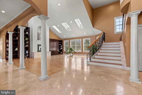 wooden floor fireplace and windows in an empty room
