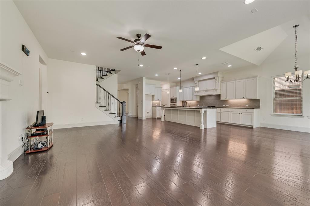 2021 Calisto Way Allen, TX 75013 - Photo 13 of 34 Spacious open-concept living area featuring wood-finish flooring, a vaulted ceiling, and a ceiling fan