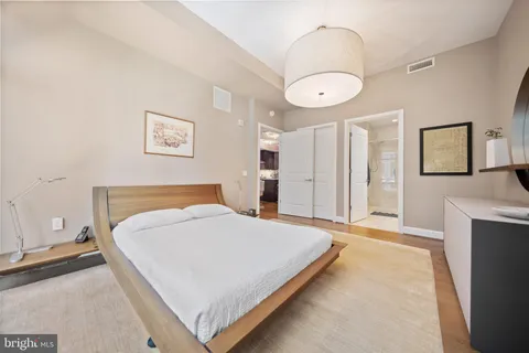 a bedroom with a bed and a chandelier