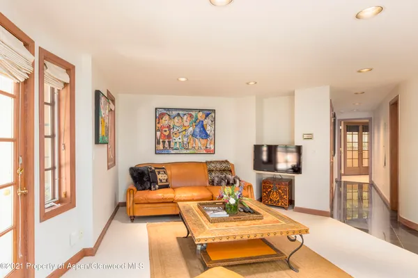 a bedroom with furniture and a flat screen tv