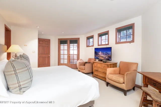 a spacious bedroom with a bed and a couch