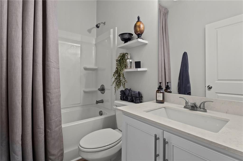 2081 Nunnally Farm Road Monroe, GA 30655 - Photo 27 of 44 a bathroom with a sink a toilet and shower