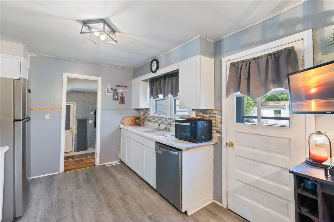 6170 Locust Street Williamson, NY 14589 - Photo 11 of 26 The kitchen to the FINISHED garage space - also th