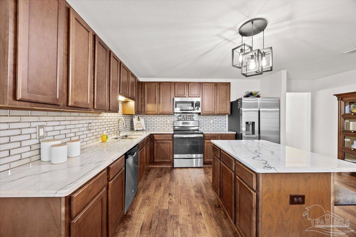 3473 Quail Drive Pace, FL 32571 - Photo 14 of 38 a kitchen with a sink a counter space and appliances