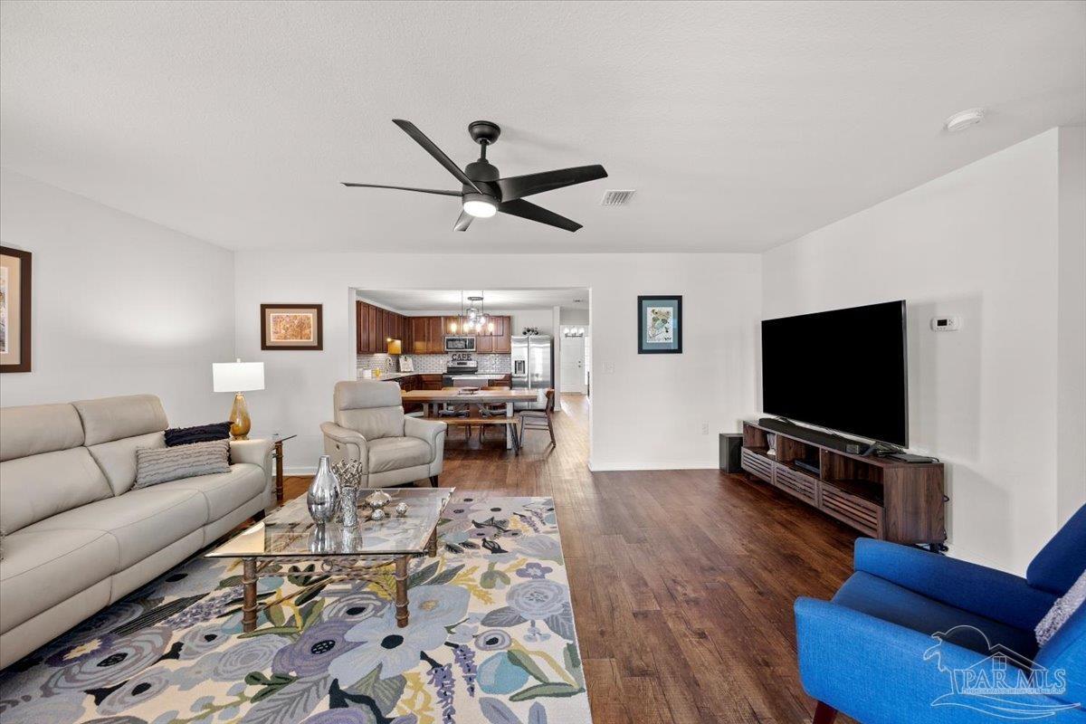 3473 Quail Drive Pace, FL 32571 - Photo 16 of 38 a living room with furniture and a flat screen tv