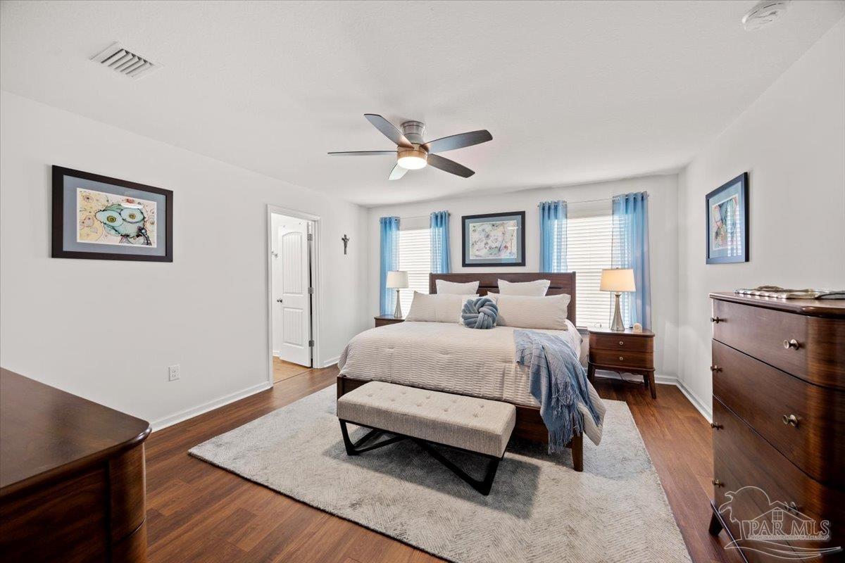 3473 Quail Drive Pace, FL 32571 - Photo 21 of 38 a spacious bedroom with a bed and a table in it