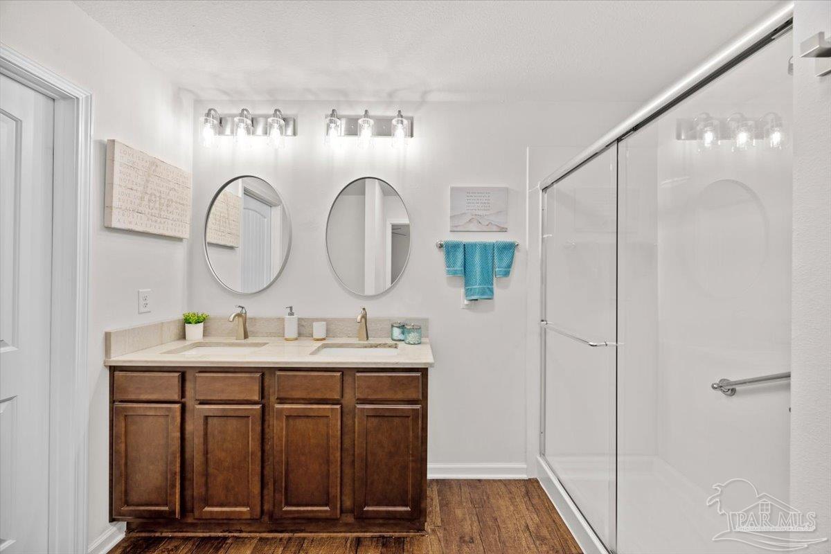 3473 Quail Drive Pace, FL 32571 - Photo 22 of 38 a bathroom with a double vanity sink and a mirror