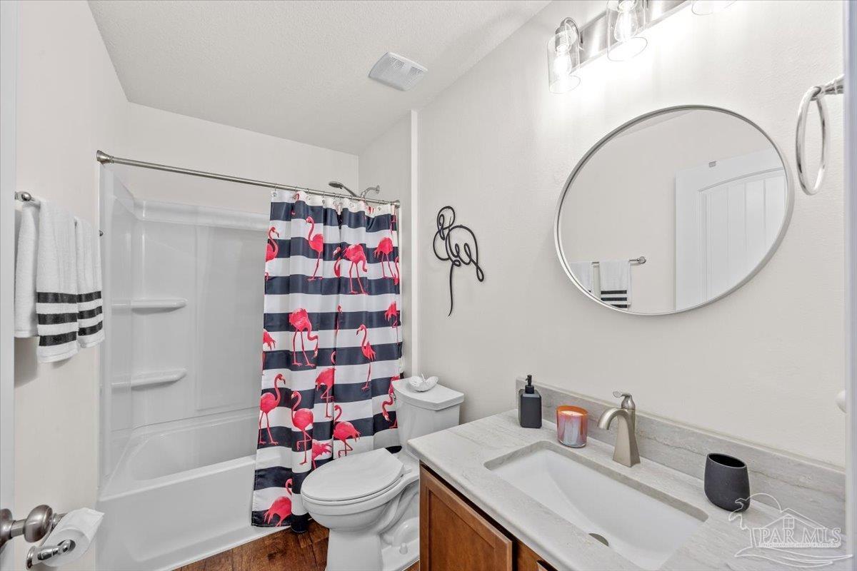 3473 Quail Drive Pace, FL 32571 - Photo 25 of 38 a bathroom with a sink mirror toilet and shower