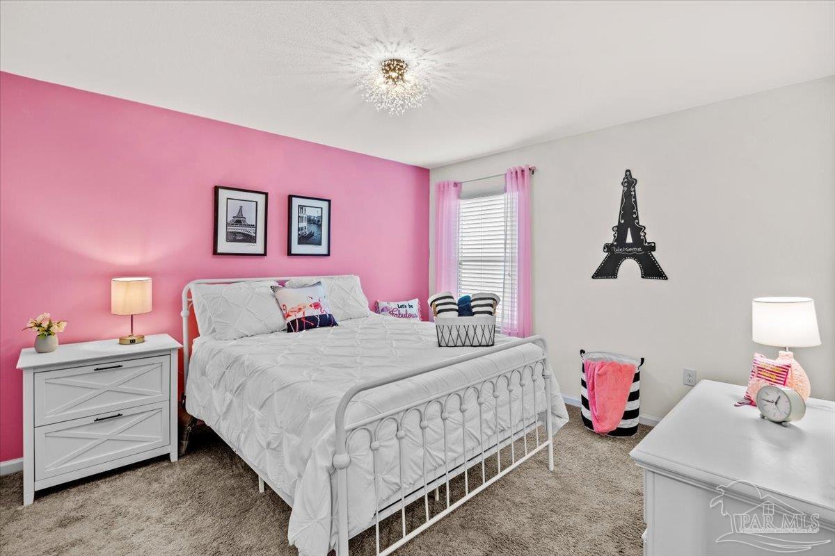 3473 Quail Drive Pace, FL 32571 - Photo 27 of 38 a bedroom with a bed and a dresser