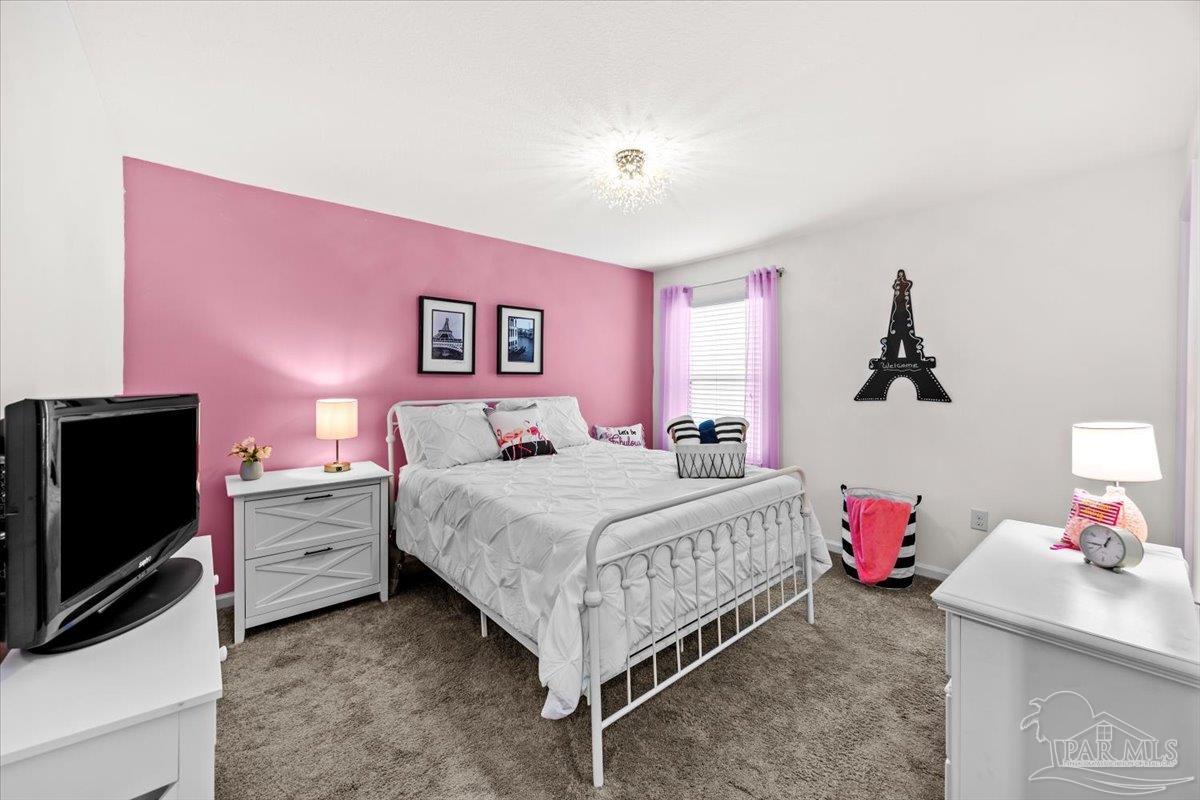 3473 Quail Drive Pace, FL 32571 - Photo 28 of 38 a bedroom with a bed and a flat screen tv