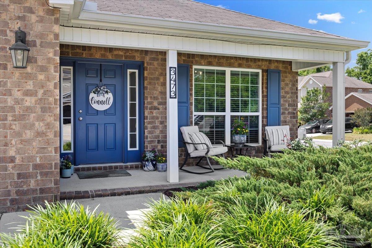 3473 Quail Drive Pace, FL 32571 - Photo 3 of 38 a view of front door of house with outdoor seating