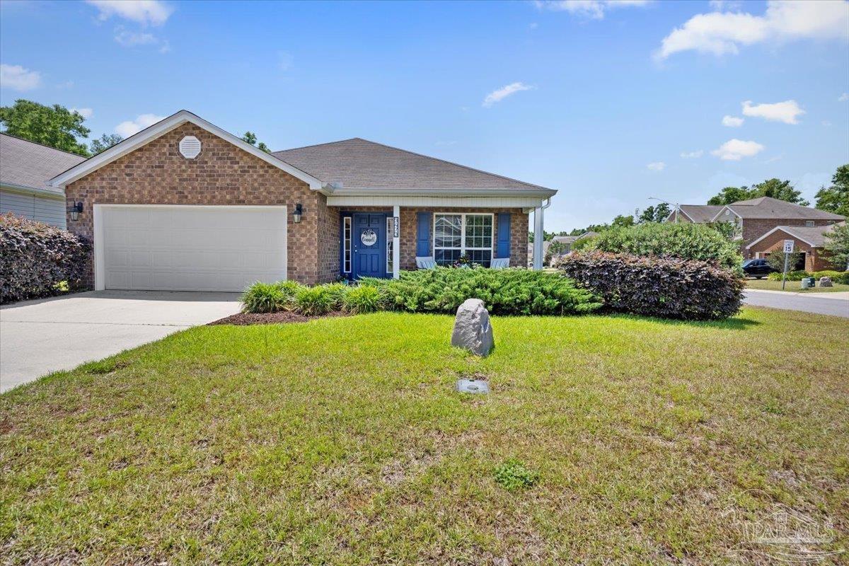 3473 Quail Drive Pace, FL 32571 - Photo 37 of 38 a front view of a house with a yard and garage