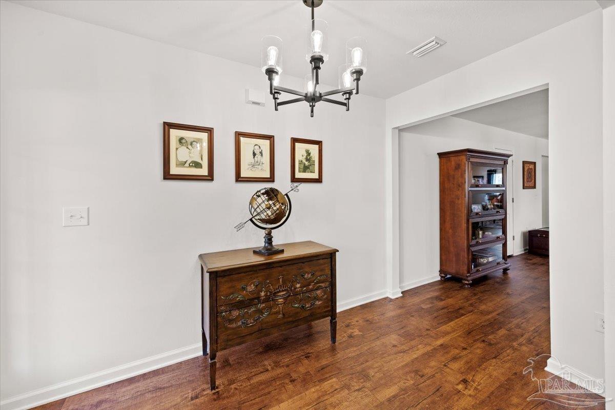 3473 Quail Drive Pace, FL 32571 - Photo 4 of 38 a view of a livingroom with furniture and wooden floor