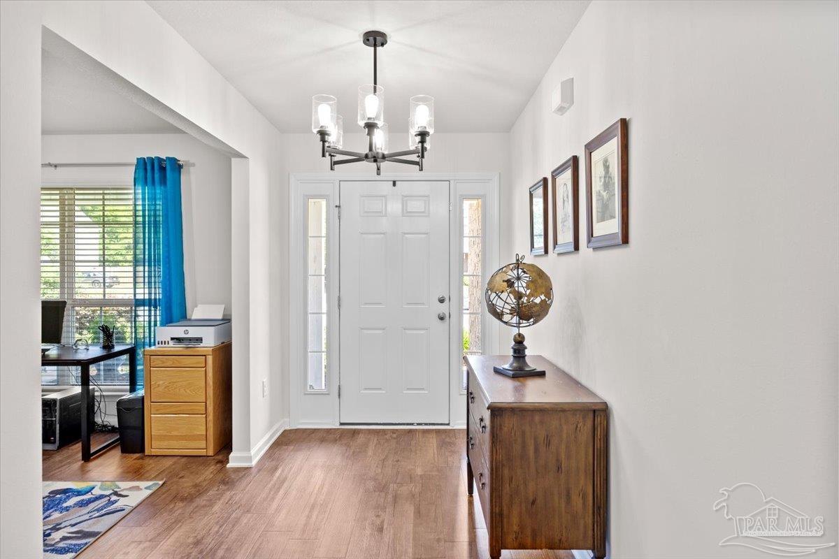 3473 Quail Drive Pace, FL 32571 - Photo 5 of 38 a view of a hallway with entryway wooden floor and front door
