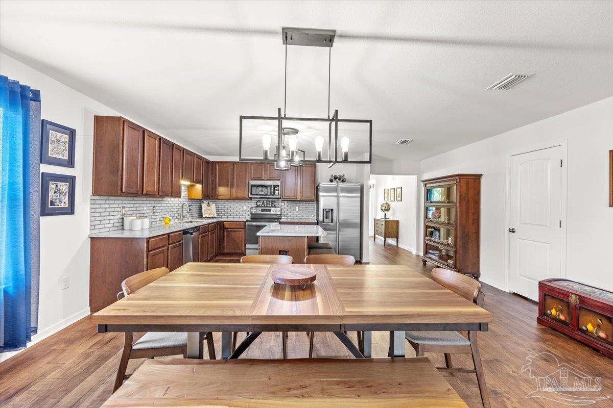 3473 Quail Drive Pace, FL 32571 - Photo 7 of 38 a living room with lots of furniture and kitchen view