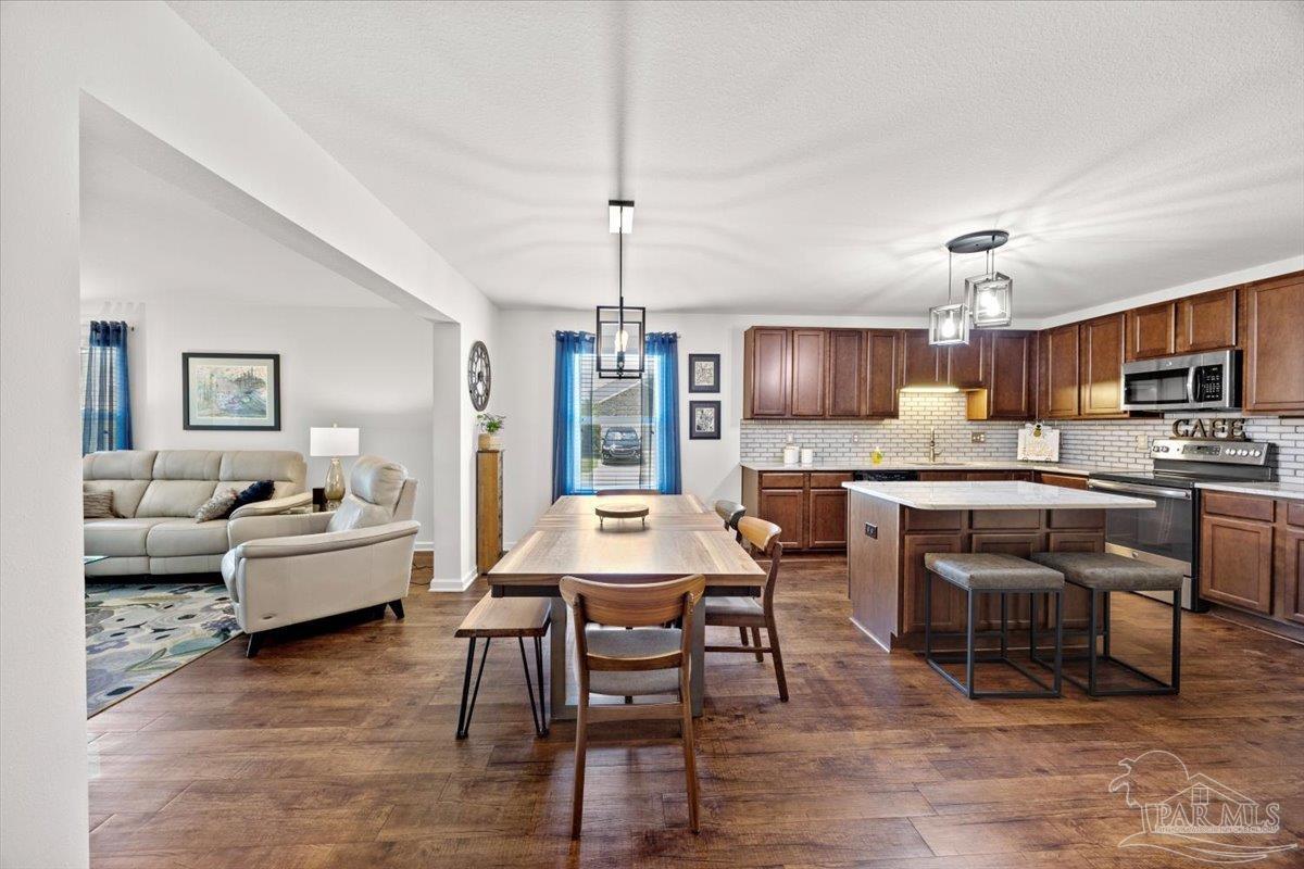 3473 Quail Drive Pace, FL 32571 - Photo 9 of 38 a large kitchen with a table and chairs