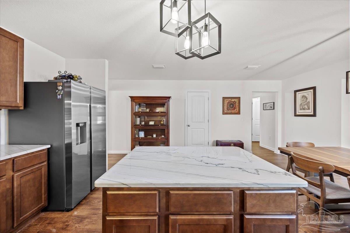 3473 Quail Drive Pace, FL 32571 - Photo 10 of 38 a dining table sitting next to a window
