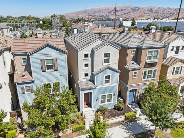 an aerial view of a house with garden space and balcony