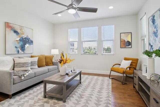 a living room with furniture and wooden floor