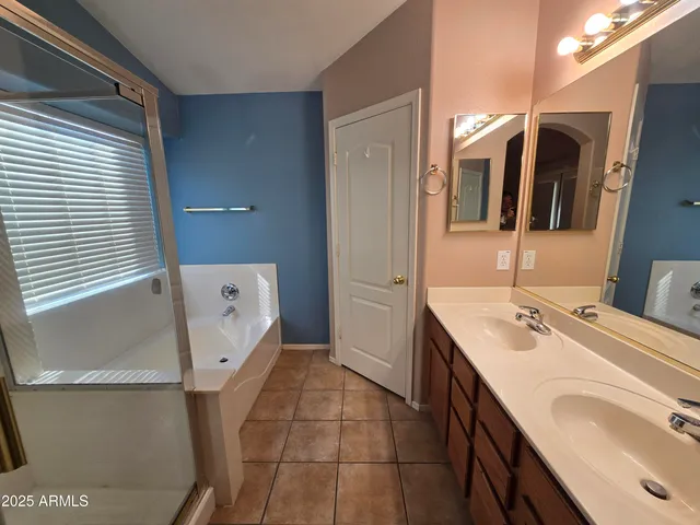 a bathroom with a sink a mirror and shower