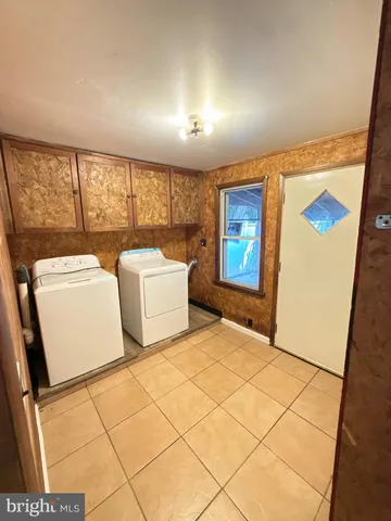 a bedroom with windows and a table