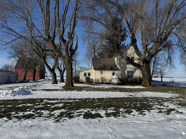 a view of a backyard with large trees