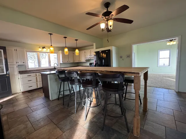 a view of a dining room with furniture and a chandelier