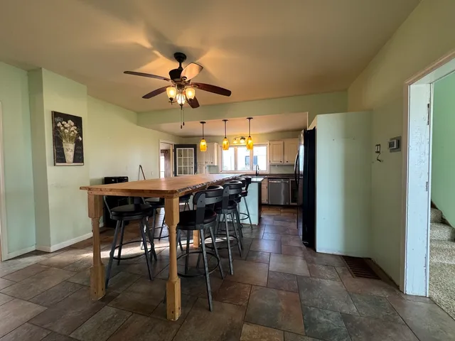 a view of a dining room with furniture and a chandelier