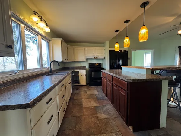 a large kitchen with lots of counter space and window