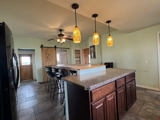 a kitchen with a counter space and a chandelier