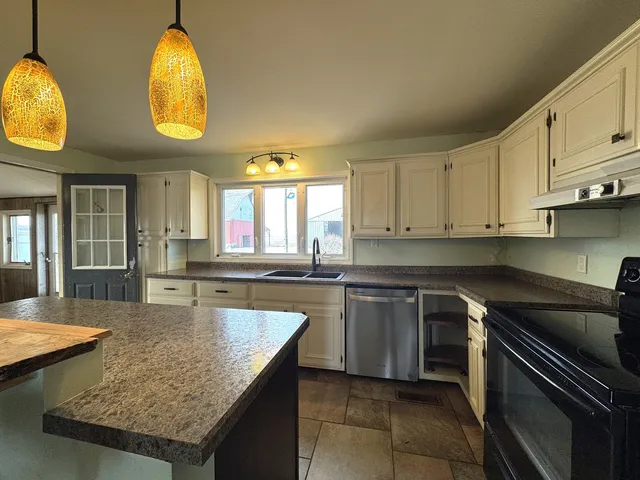 a kitchen with cabinets and window