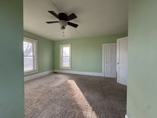 a view of an empty room with a window