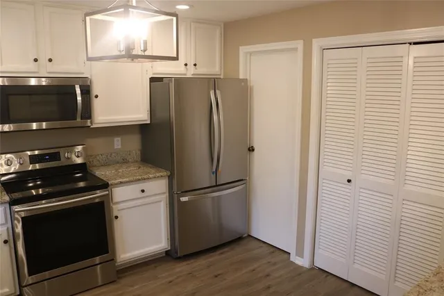 a view of an entryway with wooden floor