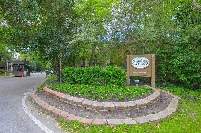 a view of a patio with a table and chairs under an umbrella