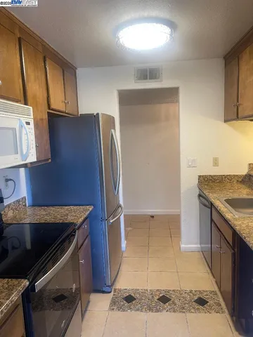 a view of empty room with fireplace and wooden floor