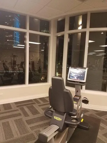 a room with gym equipment and glass door